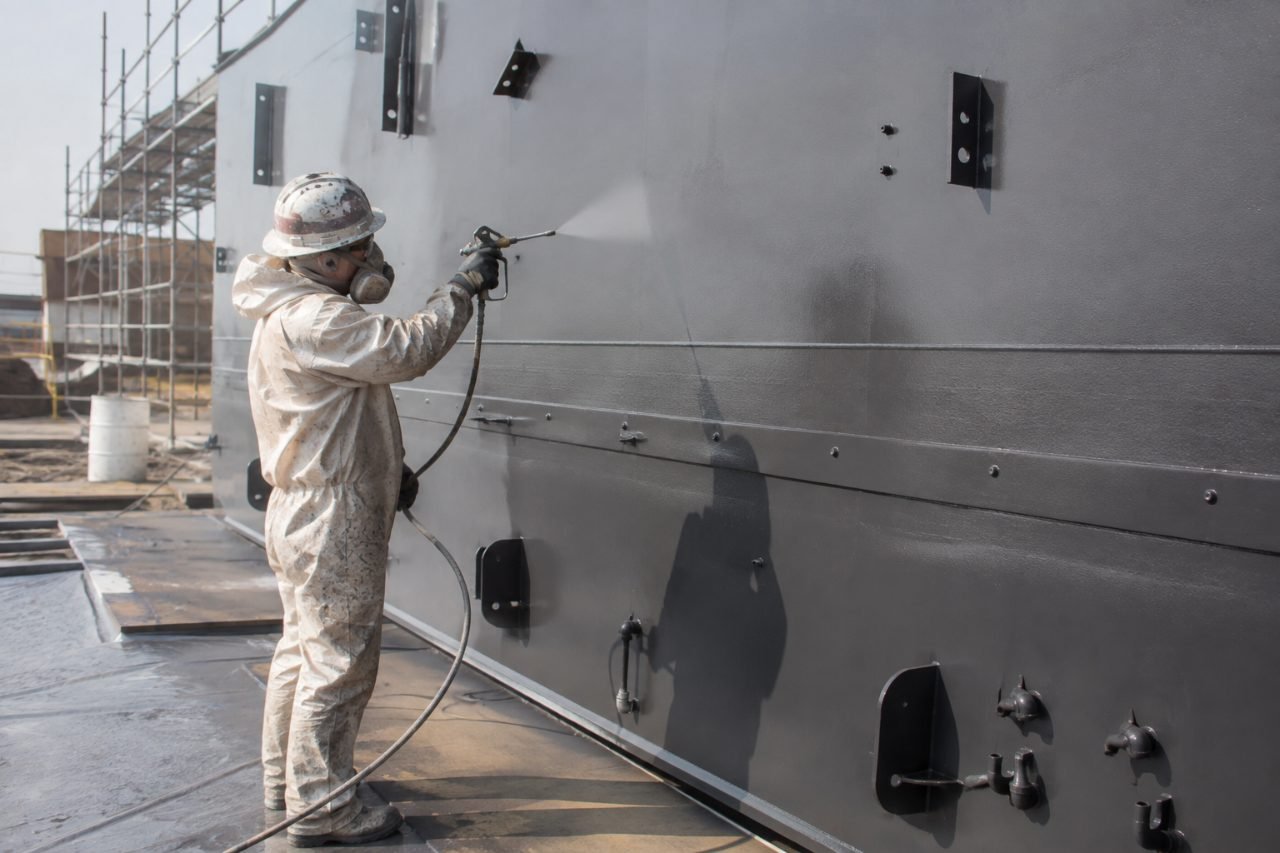 Spray applying protective coating to structural steel