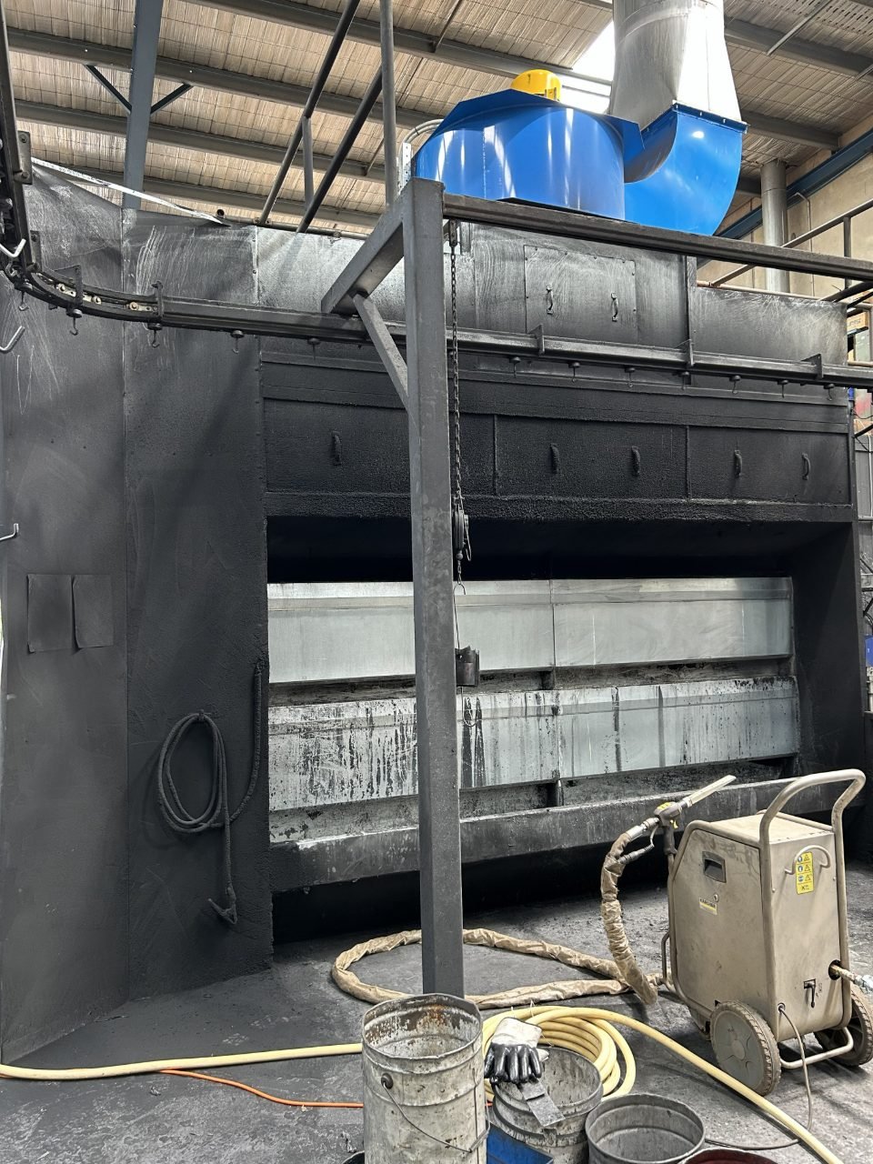 Powder coating booth heavily caked with overspray